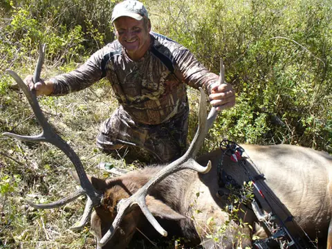 Hunter with a bull elk