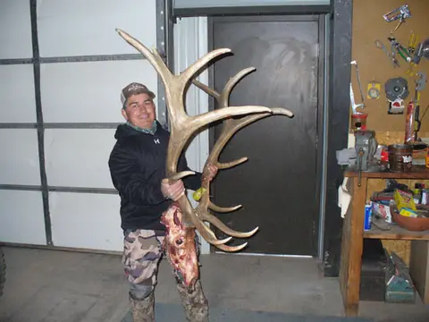 Hunter holding a large set of elk antlers