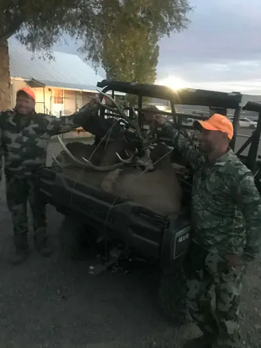 Hunters with elk loaded in a ranch vehicle